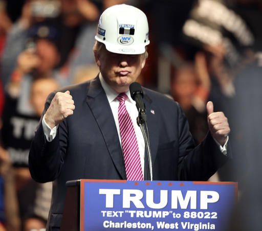 Republican presidential candidate Donald Trump puts on a miners hard hat during a rally in Charleston, W.Va., Thursday, May 5, 2016. (AP Photo/Steve Helber)